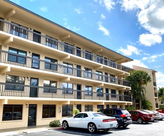 view of property with uncovered parking