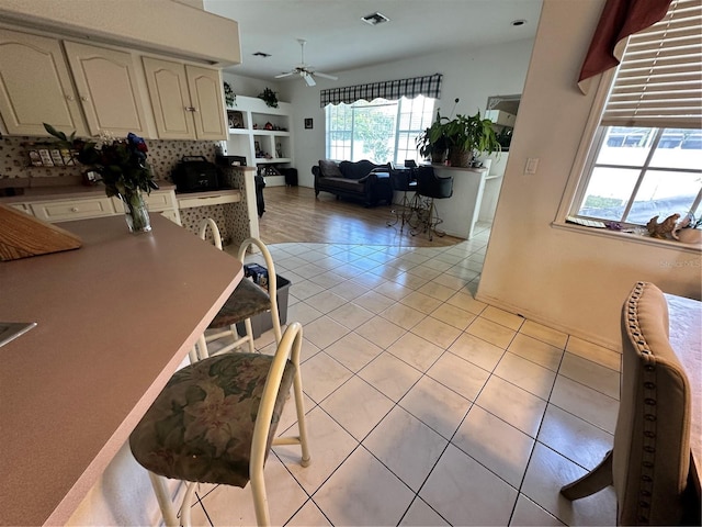 dining space featuring light tile patterned floors, visible vents, and ceiling fan