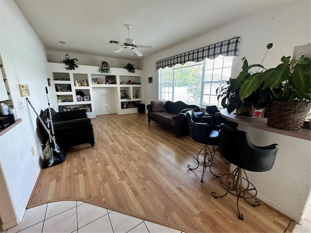 living room featuring ceiling fan and light wood-style floors