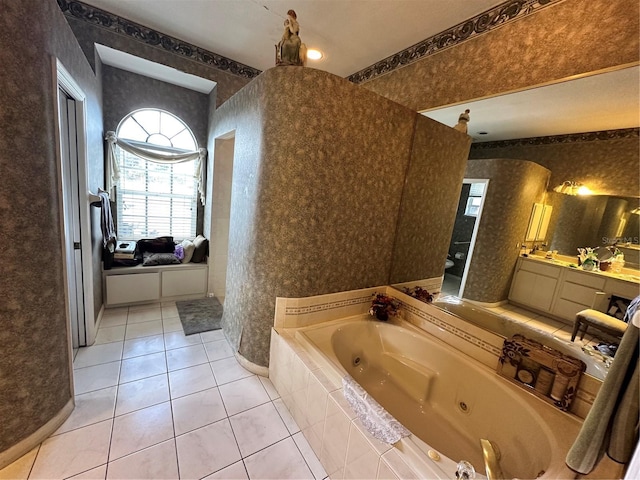 full bath with tile patterned floors, a jetted tub, vanity, and wallpapered walls