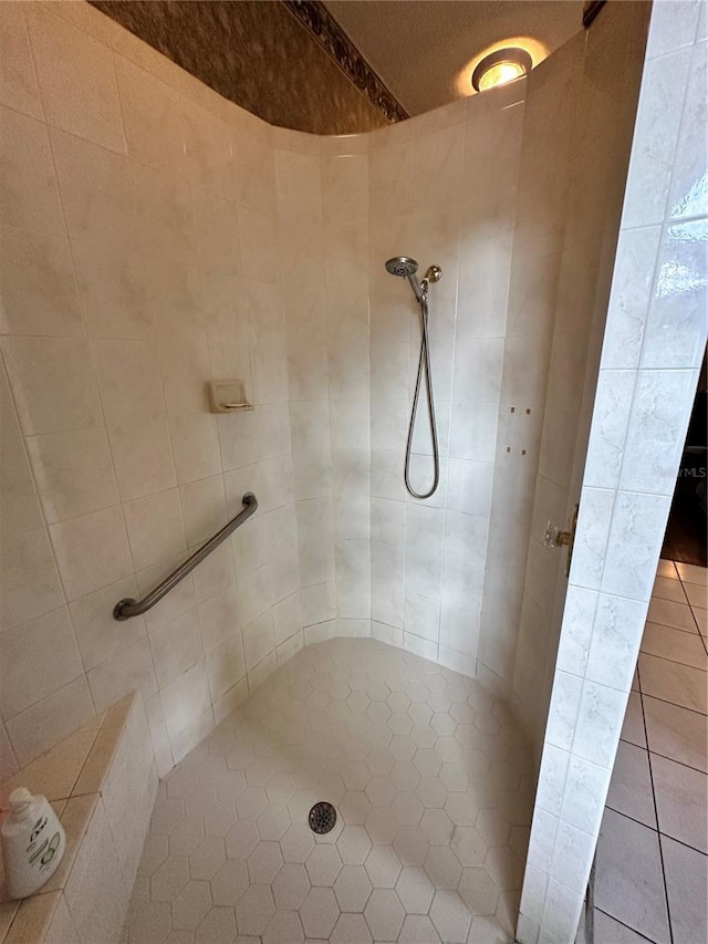 bathroom with tiled shower