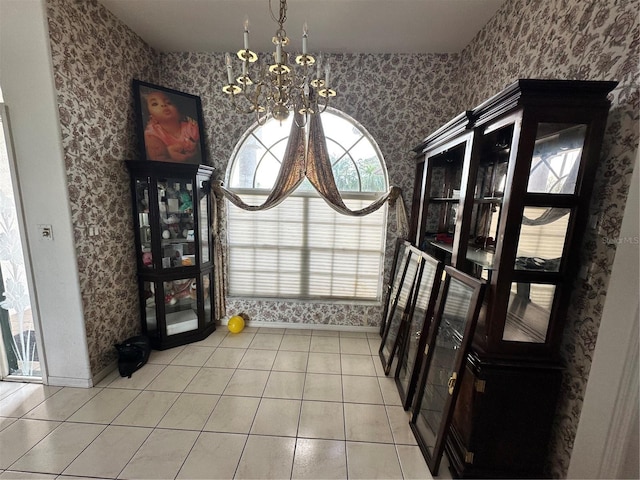 dining room with baseboards, a chandelier, tile patterned flooring, and wallpapered walls