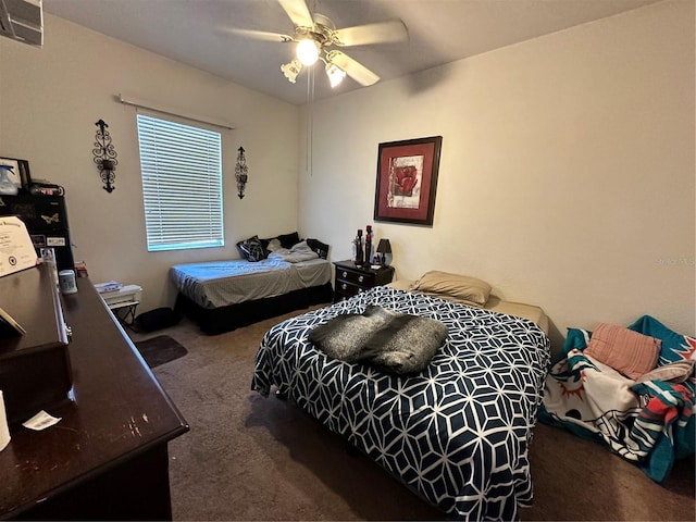 carpeted bedroom with visible vents and ceiling fan