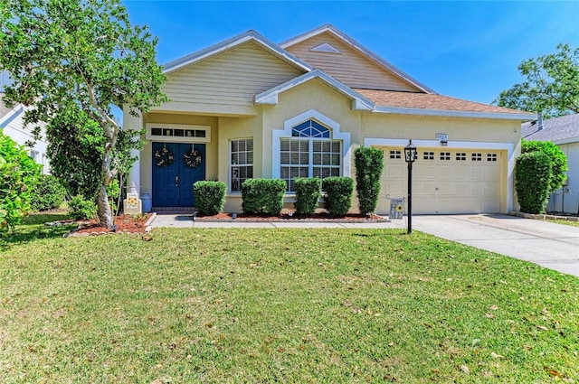 view of front of house with stucco siding, driveway, a front yard, and an attached garage