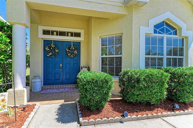 property entrance with stucco siding