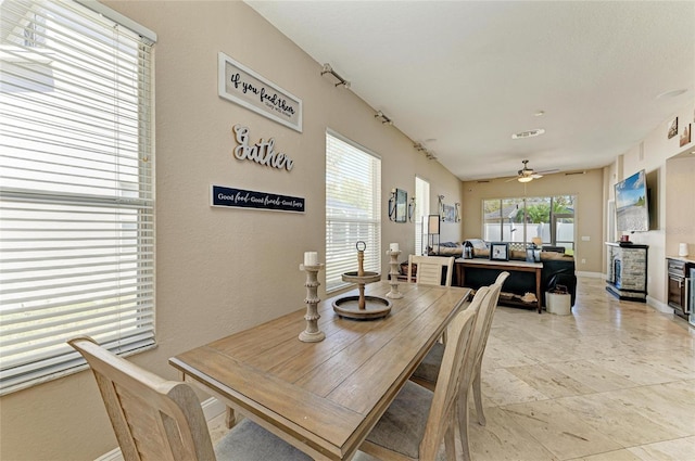 dining area featuring baseboards and a ceiling fan