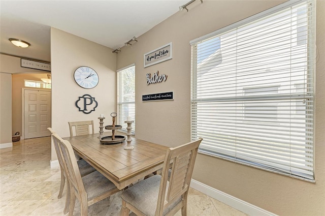 dining room with a healthy amount of sunlight and baseboards