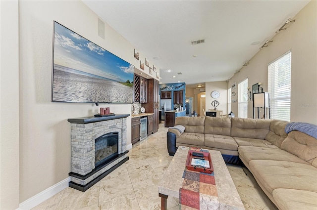 living room with visible vents, baseboards, wine cooler, recessed lighting, and a fireplace