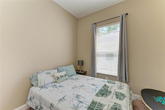 bedroom featuring carpet and baseboards