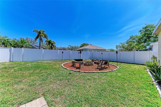 view of yard with a fire pit and a fenced backyard