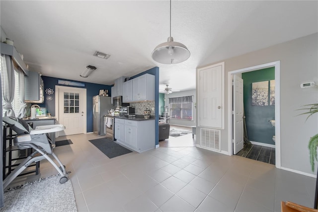 kitchen with visible vents, backsplash, stainless steel appliances, and ceiling fan