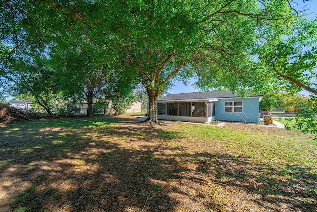 view of yard with fence and a sunroom