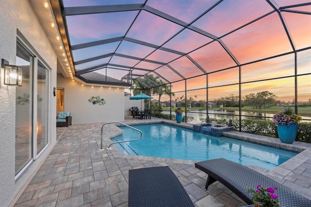 view of swimming pool with glass enclosure, a patio, and a pool with connected hot tub