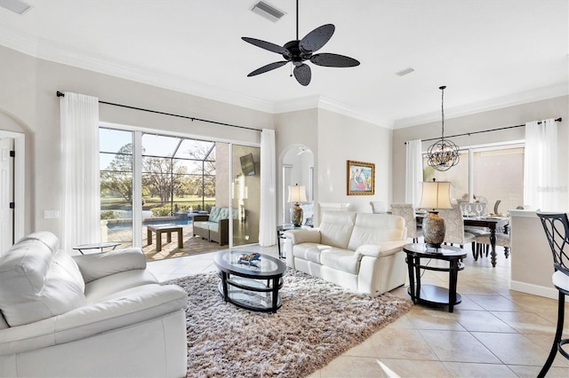 living room with light tile patterned floors, visible vents, ceiling fan with notable chandelier, and ornamental molding