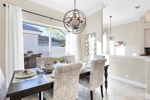 tiled dining space with a notable chandelier, baseboards, visible vents, and ornamental molding