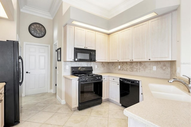 kitchen featuring backsplash, crown molding, light tile patterned flooring, black appliances, and a sink