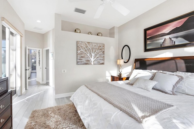 bedroom with light wood finished floors, visible vents, a ceiling fan, and baseboards