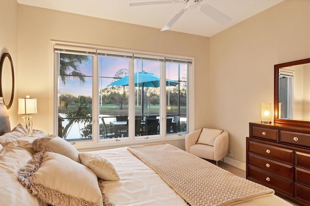 bedroom featuring baseboards and ceiling fan