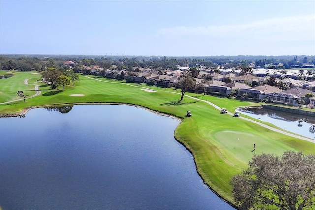 bird's eye view featuring golf course view, a water view, and a residential view