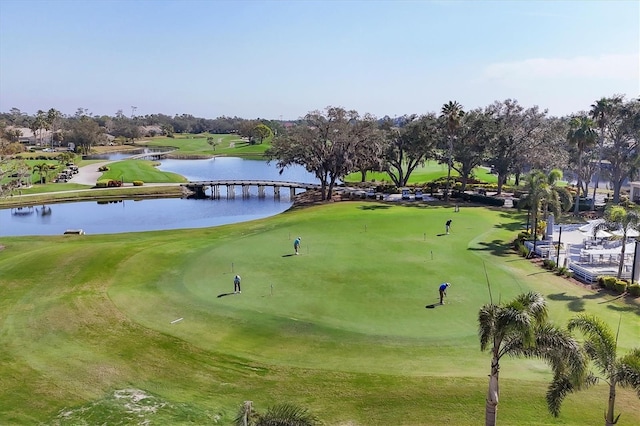 view of community featuring golf course view and a water view