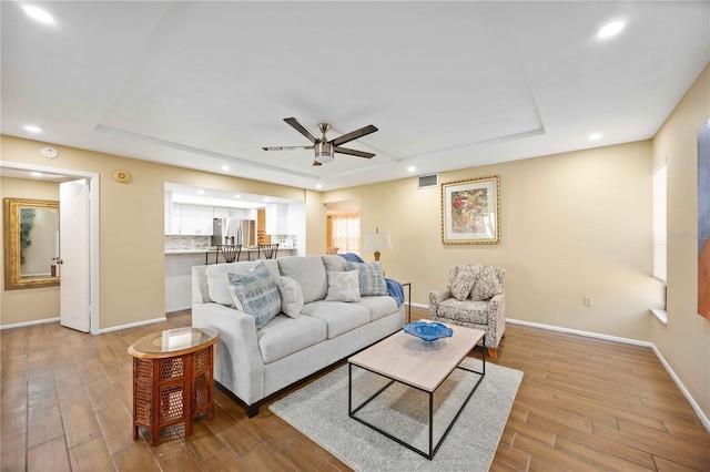2347 Beneva Ter Unit 2251, Sarasota, FL 34232 - living room featuring ceiling fan, a tray ceiling, visible vents, baseboards, and wood finished floors