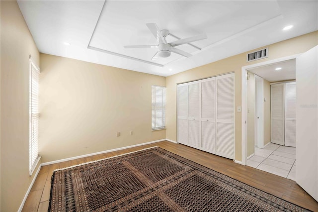 2347 Beneva Ter Unit 2251, Sarasota, FL 34232 - unfurnished bedroom with wood finished floors, a closet, baseboards, visible vents, and a raised ceiling