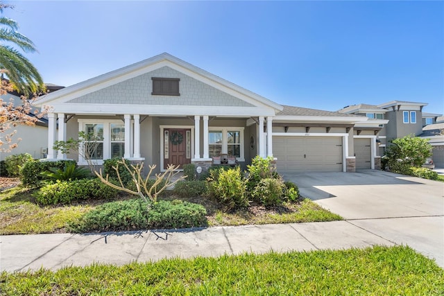 view of front of home with a garage, concrete driveway, and stucco siding