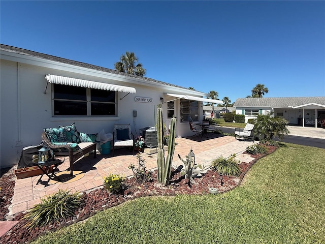 back of house with a patio area, central air condition unit, and a lawn