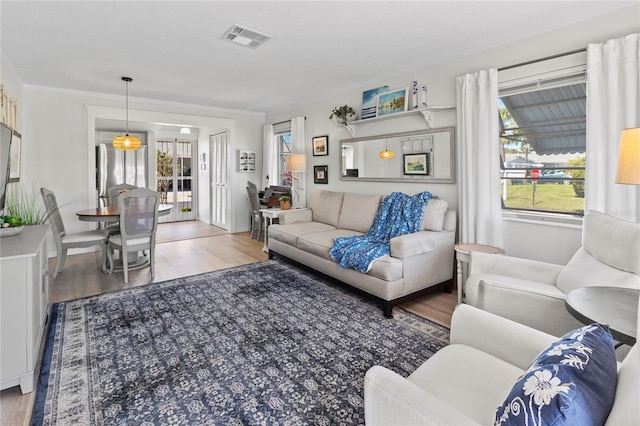 living room with visible vents and wood finished floors