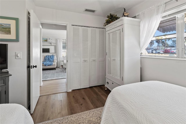 bedroom with wood finished floors and visible vents