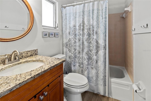 full bathroom with vanity, toilet, wood finished floors, and shower / tub combo with curtain