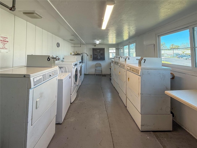 shared laundry area featuring washer and dryer, visible vents, and a textured ceiling