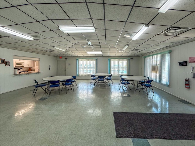 recreation room with tile patterned floors, a paneled ceiling, visible vents, and ceiling fan