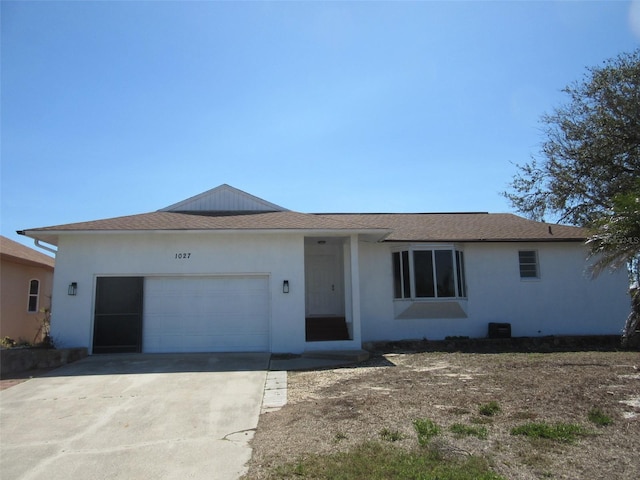 single story home with stucco siding, a garage, concrete driveway, and a shingled roof