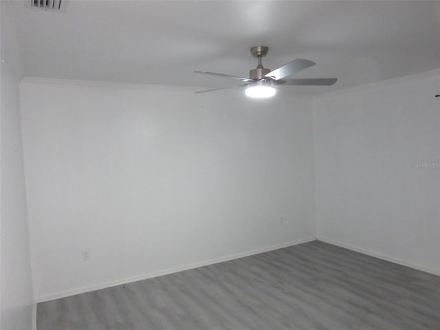 unfurnished room featuring ceiling fan, baseboards, and wood finished floors