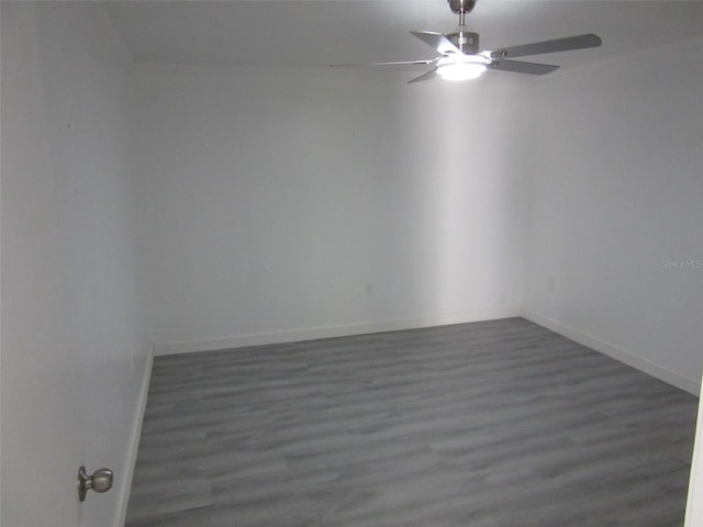 empty room featuring baseboards, wood finished floors, and a ceiling fan