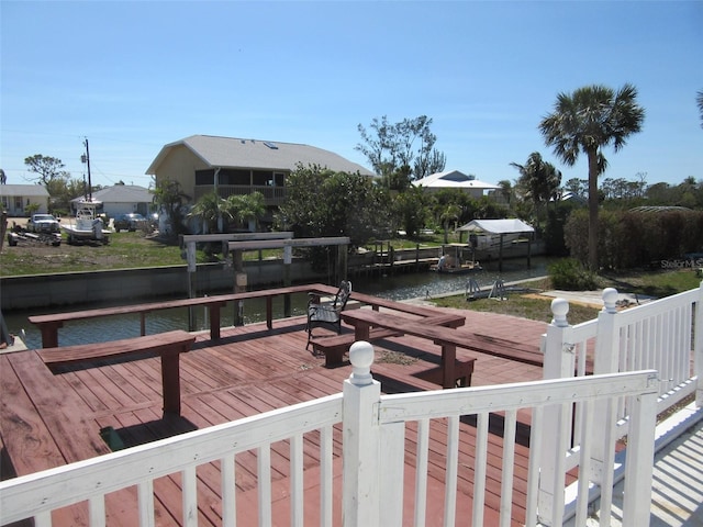 view of dock featuring a deck with water view