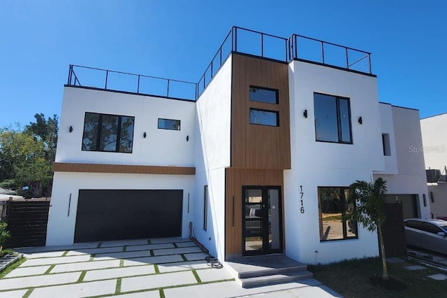 contemporary home with a garage and stucco siding