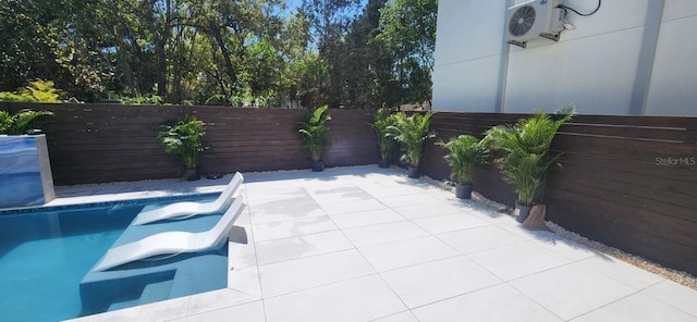 view of pool featuring ac unit, a fenced in pool, a patio, and fence