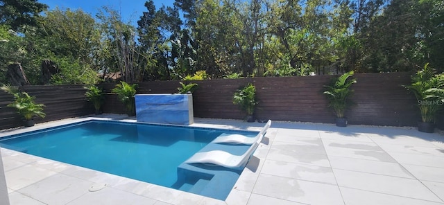 view of swimming pool with a fenced in pool, a fenced backyard, and a patio area