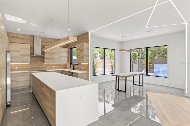 1716 9th St, Sarasota, FL 34236 - kitchen featuring plenty of natural light, light countertops, modern cabinets, and wall chimney range hood