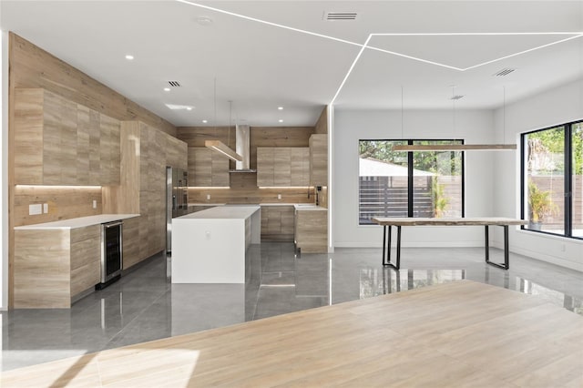 1716 9th St, Sarasota, FL 34236 - kitchen with freestanding refrigerator, wine cooler, modern cabinets, a center island, and recessed lighting
