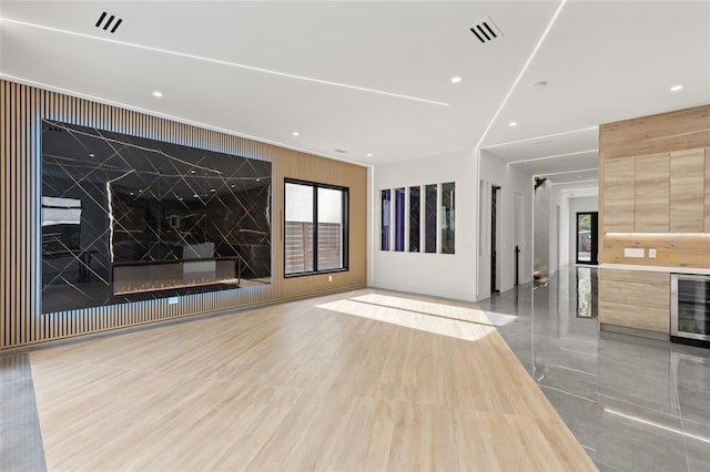 1716 9th St, Sarasota, FL 34236 - unfurnished living room featuring wine cooler, wood walls, recessed lighting, and visible vents