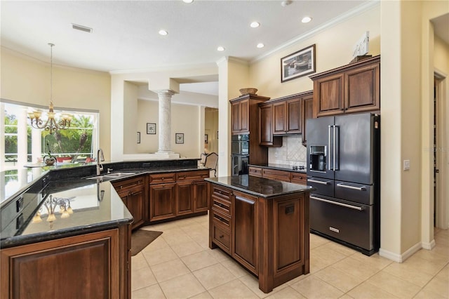 kitchen featuring tasteful backsplash, ornamental molding, high end fridge, dobule oven black, and a sink