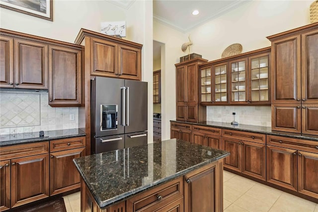 kitchen with high end fridge, ornamental molding, backsplash, light tile patterned floors, and black electric stovetop