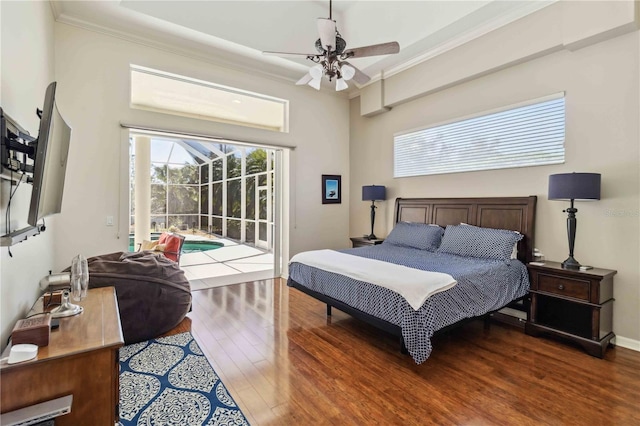 bedroom featuring access to exterior, crown molding, baseboards, a sunroom, and wood finished floors