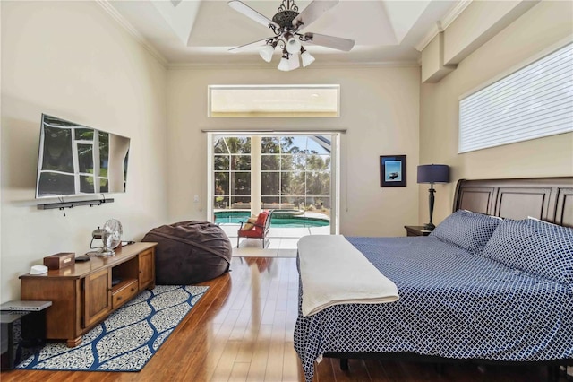 bedroom with hardwood / wood-style floors, access to outside, a ceiling fan, and ornamental molding