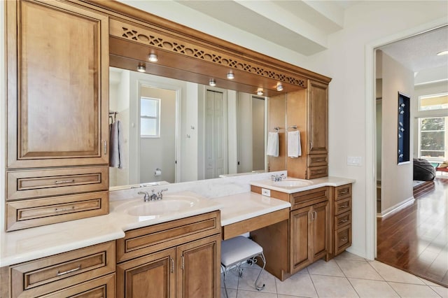 bathroom with tile patterned flooring, double vanity, and a sink