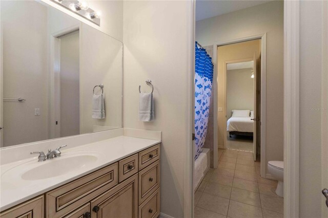 full bath featuring tile patterned flooring, toilet, and vanity