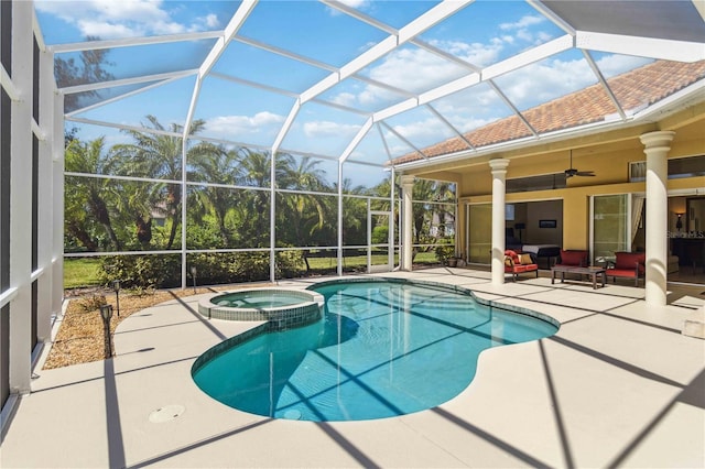 view of swimming pool featuring glass enclosure, a ceiling fan, a pool with connected hot tub, a patio area, and an outdoor hangout area